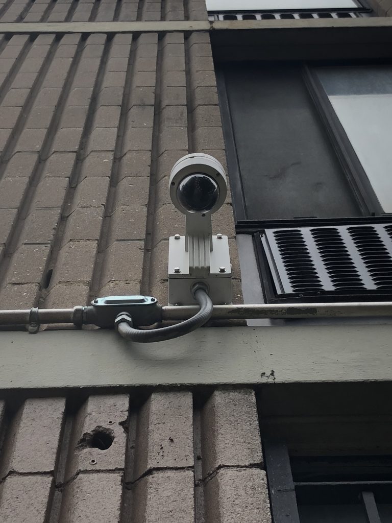 Close up view of Security Camera installed on an exterior concrete wall