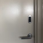 Close up of Residential bike room door shown with proximity reader and door handle