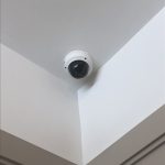 Security dome camera shown installed on an interior ceiling in a corner